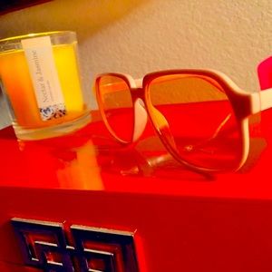 Modern light pink sunglasses with polymer frames. Translucent pink lenses.